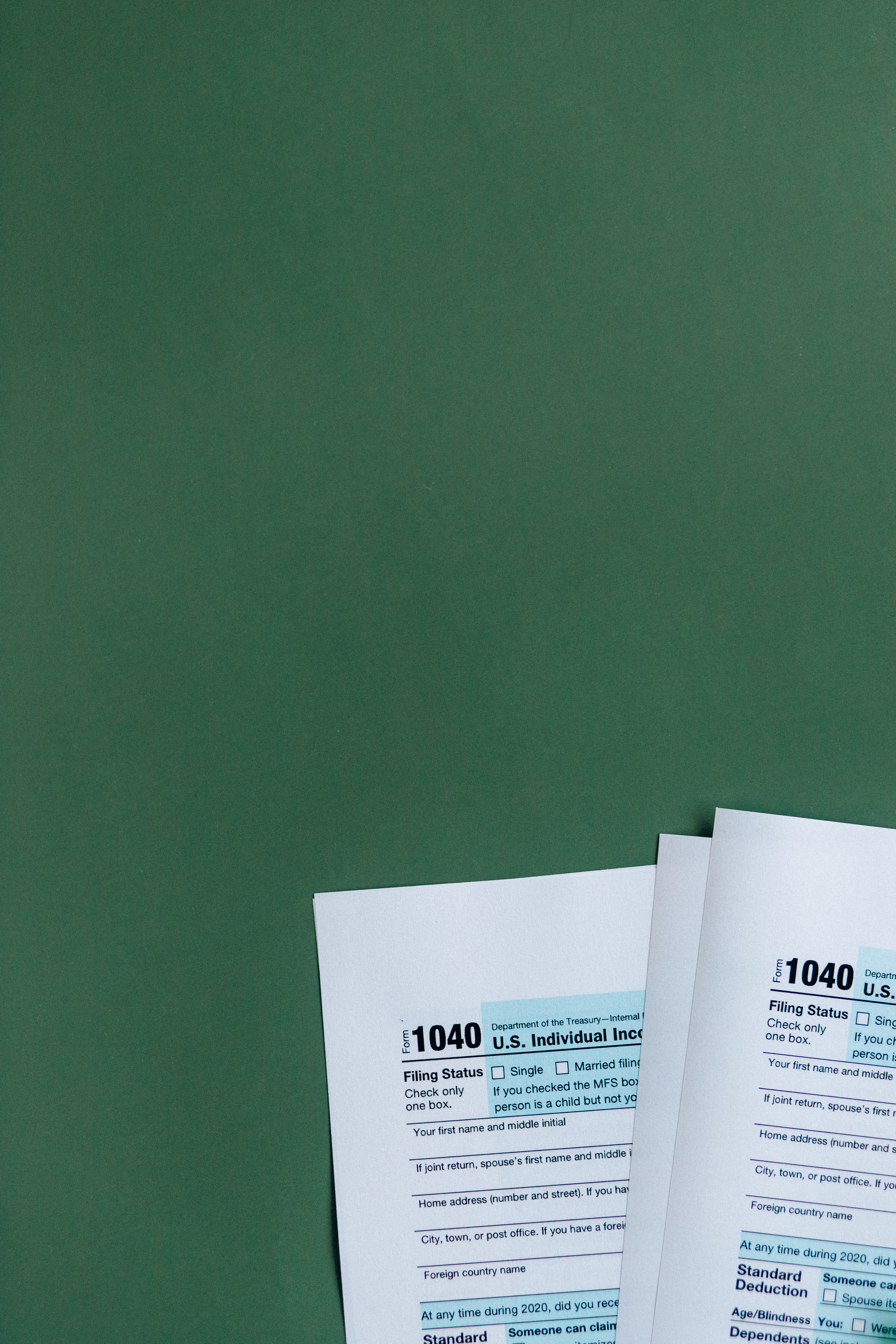 Image of Form 1040s in a green background